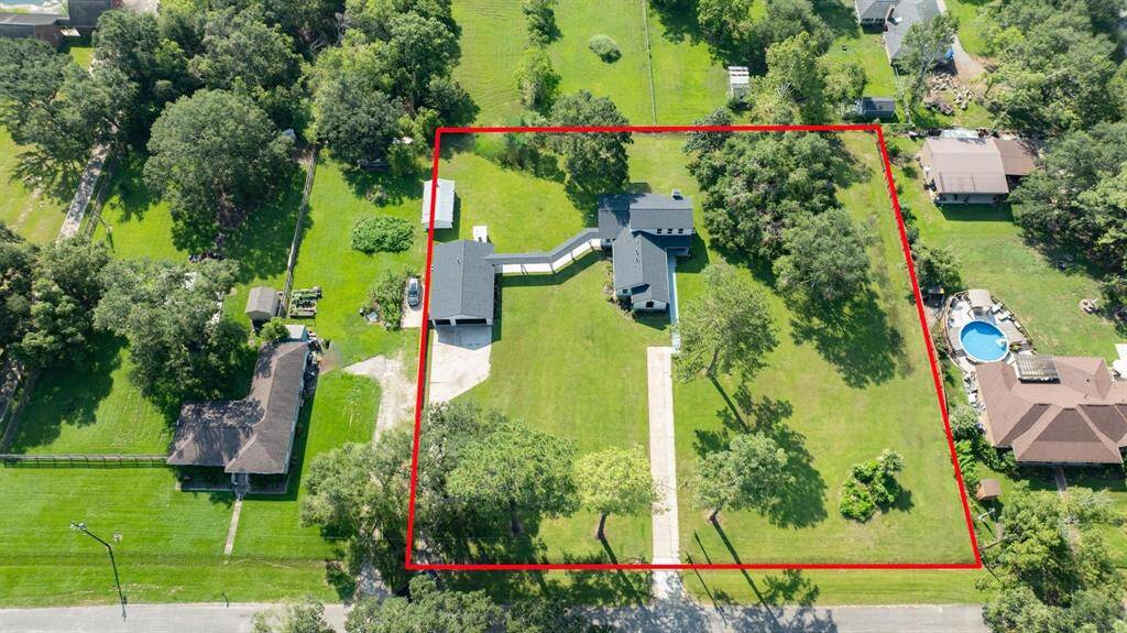 Peaceful And Tranquil Setting. Aerial view of this luxury estate with renovated home including upscale features and finishes; the detached 4-car garage offers ~700-sq feet of climate-controlled space - great for a home-office or small business.