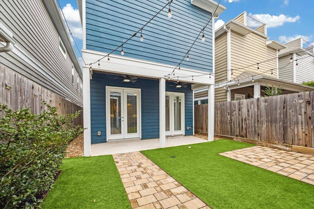 Designed for effortless outdoor living, this inviting covered back porch offers a shaded retreat with dual ceiling fans for year-round comfort. French doors provide seamless access from the interior, making it an ideal extension of the home’s living space.