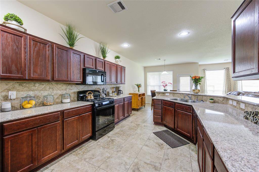 Large chef's kitchen, granite countertops, and ample cabinets.