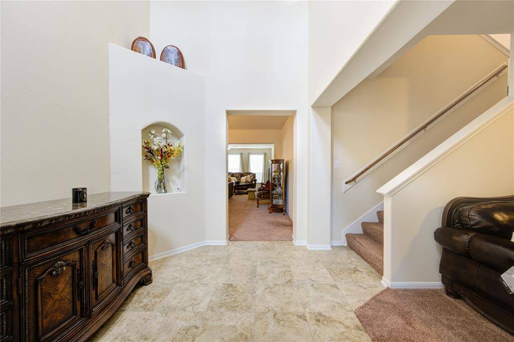 Broad stairs take you to 4 bedrooms, game room, media room, and more.