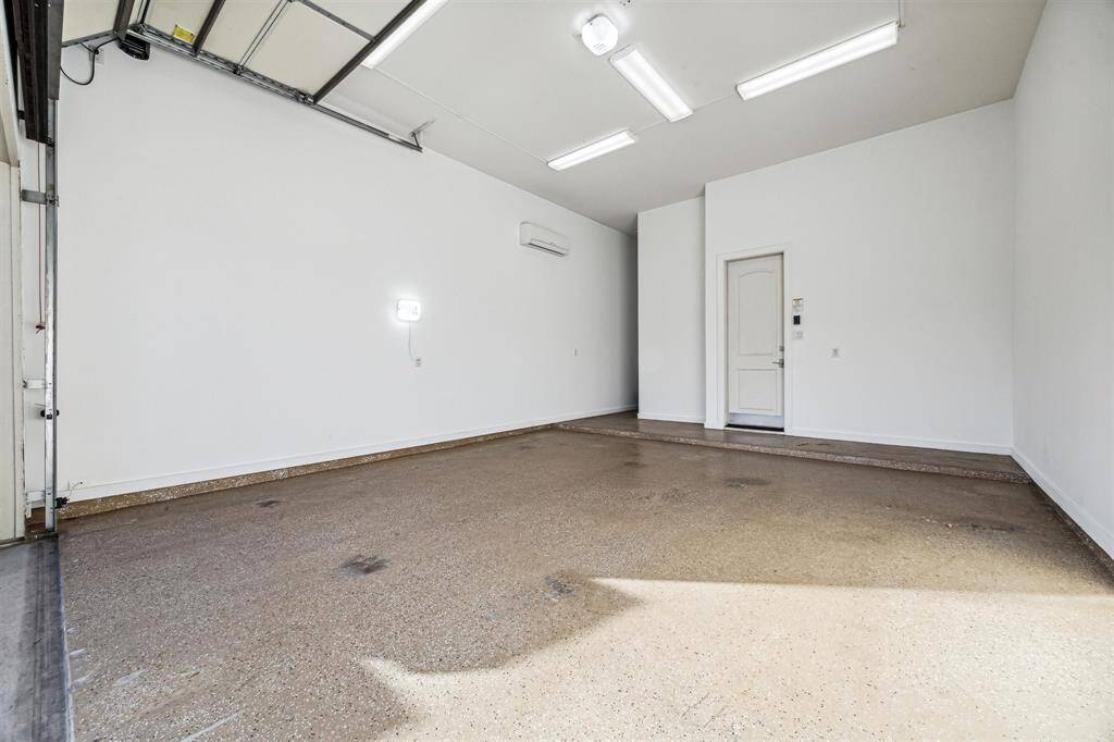 2-car garage with 12' ceiling, what has the Capacity for 4 car parking with a car left. This garage features insulated walls, Epoxy flooring and it is equipped with an air conditioner system.