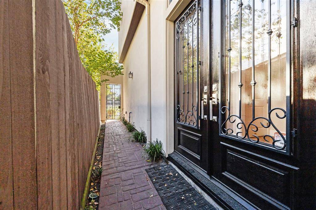 Private brick-paved entrance with an elegant Double door with wrought iron!