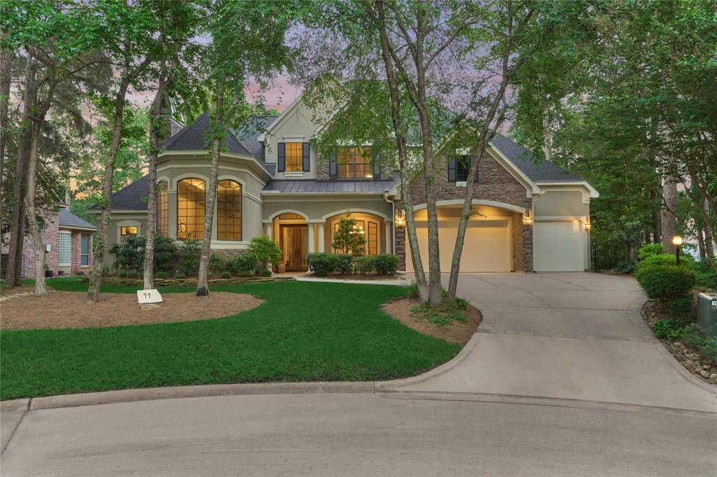 44 Waterberry Way is nestled in mature trees on a quiet cul-de-sac street in a highly desirable section of Bentwater.