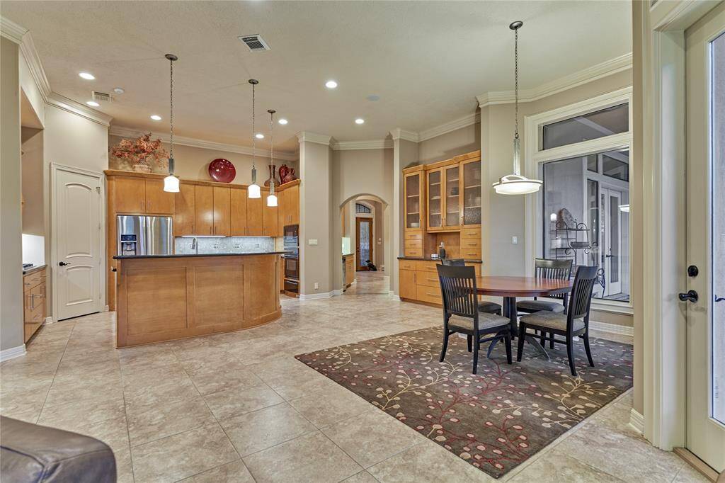 Clean lines, warm tones and opulent lighting define this culinary kitchen.