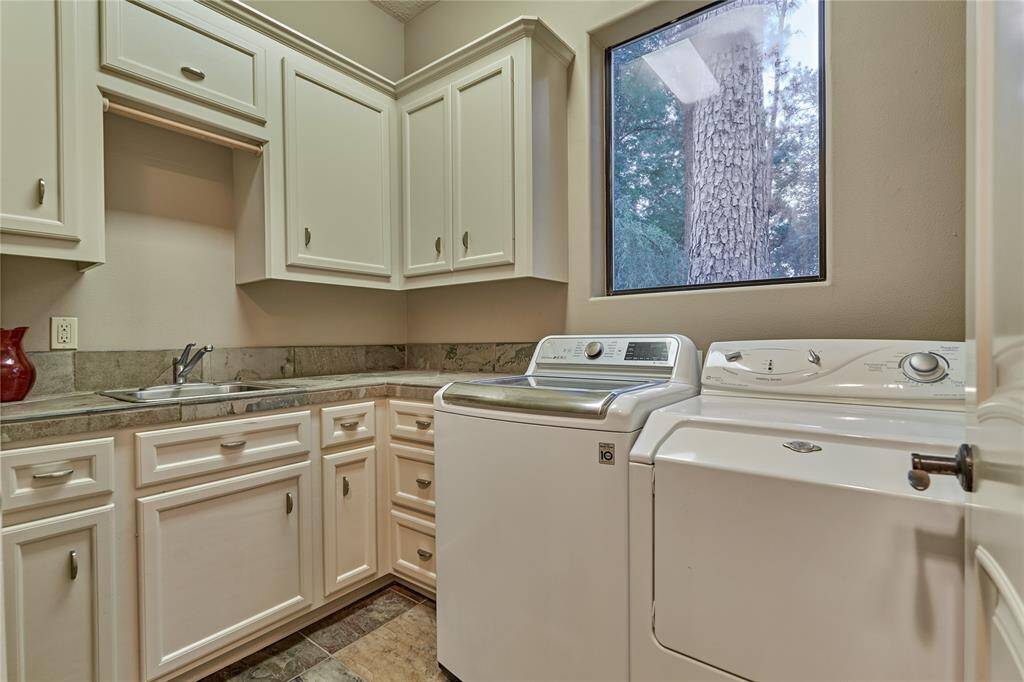 Ample storage and a utility sink in the laundry room.