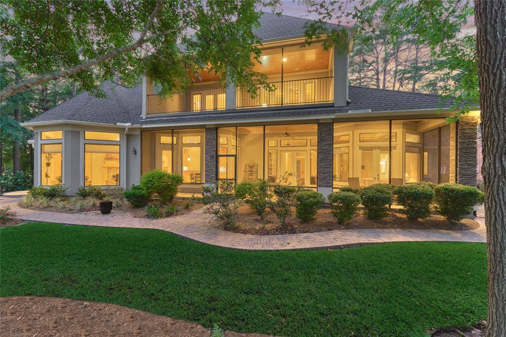 Impeccable landscape with brick pavers across the entirety of the back of the house.