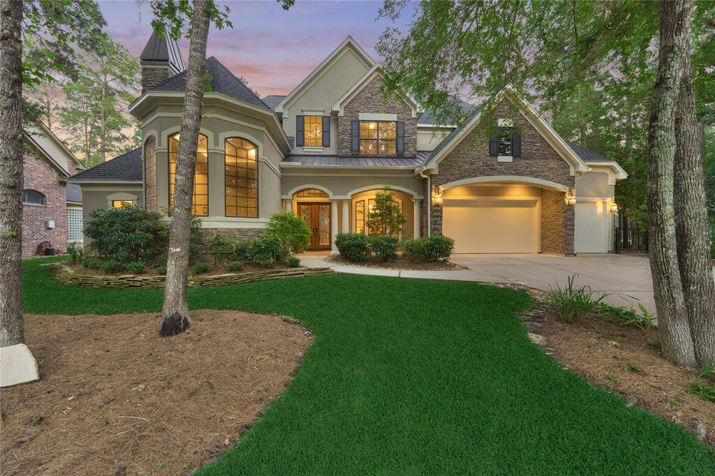 Striking stone and stucco facade with an impressive multi-gable roof.