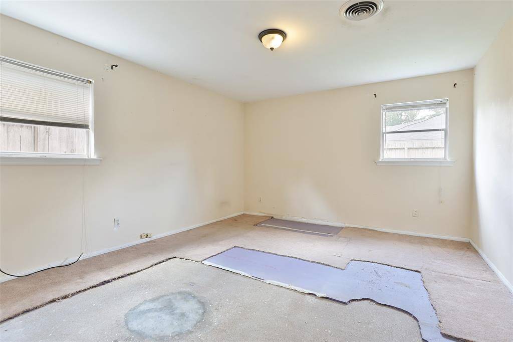 Downstairs back bedroom.  Plumbing leak in the bathroom has been fixed.  Flooring needs to be replaced.