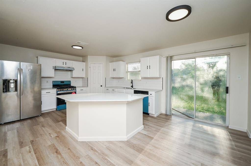Experience a refreshed kitchen with sleek new countertops, a stylish backsplash, fresh paint, and brand new stove and dishwasher.