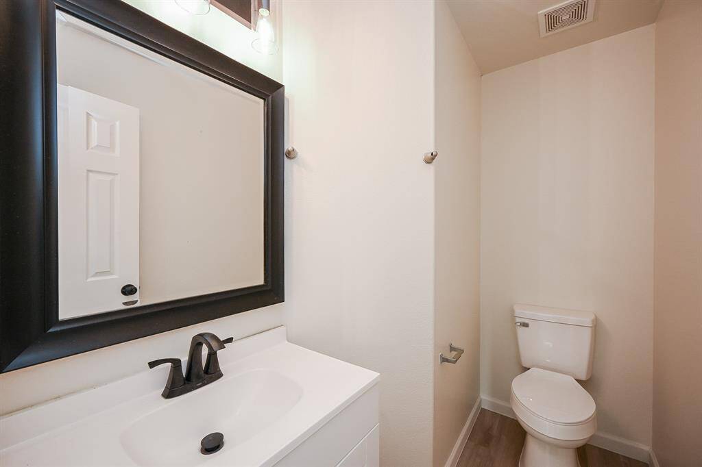 Convenient downstairs half bath with modern fixtures.