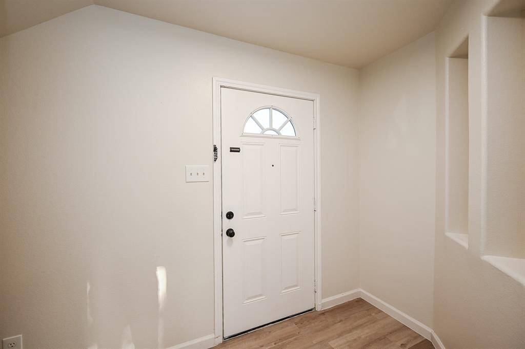 This inviting entryway offers ample space for shoe racks and decorative touches.