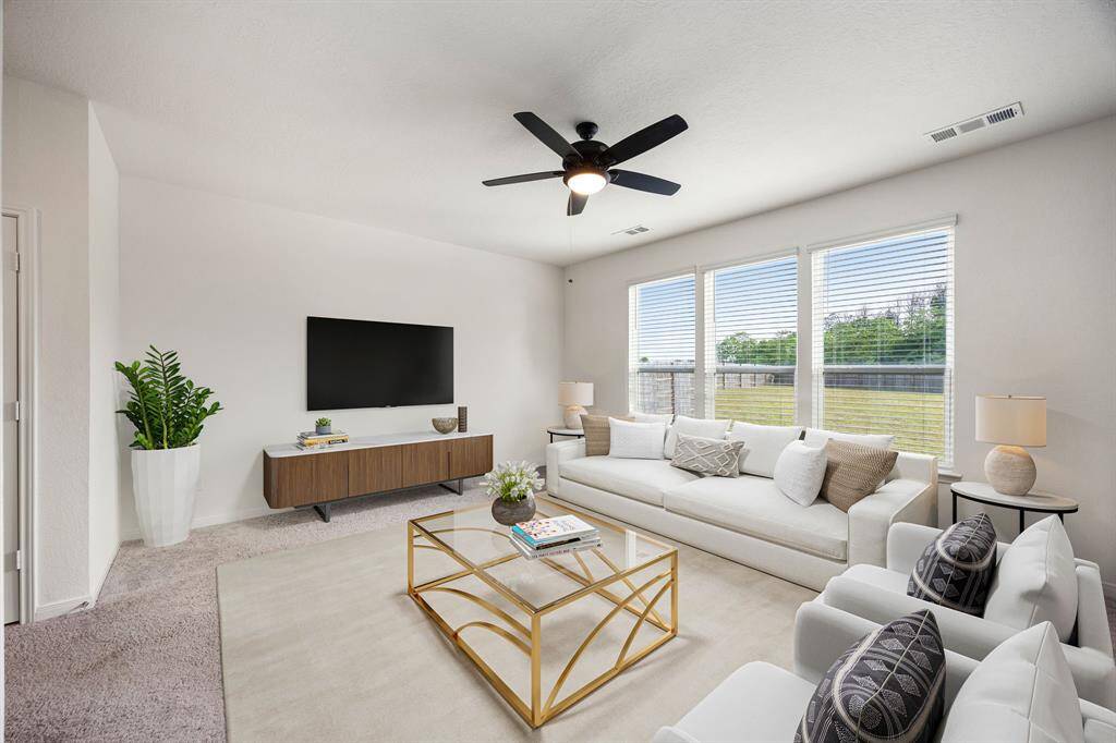 Gather the family and guests together in your lovely living room! Featuring dark stained ceiling fan, neutral paint, plush carpet floors and large windows that provide plenty of natural lighting throughout the day. *virtual staging*