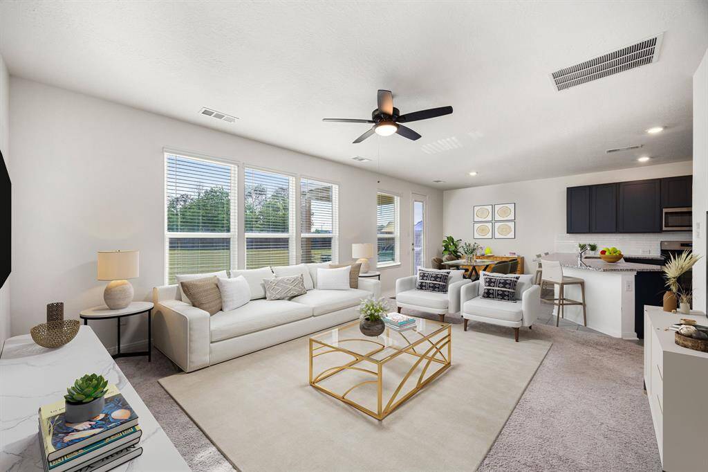 This light and bright spacious living room is the perfect layout for entertaining or just relaxing. Whether it's simply a night in or entertaining family and friends, this home has ample open space for everyone to enjoy! Featuring dark stained ceiling fan, plush carpet flooring, large windows with blinds with wonderful access to your gorgeous kitchen.*virtual staging*