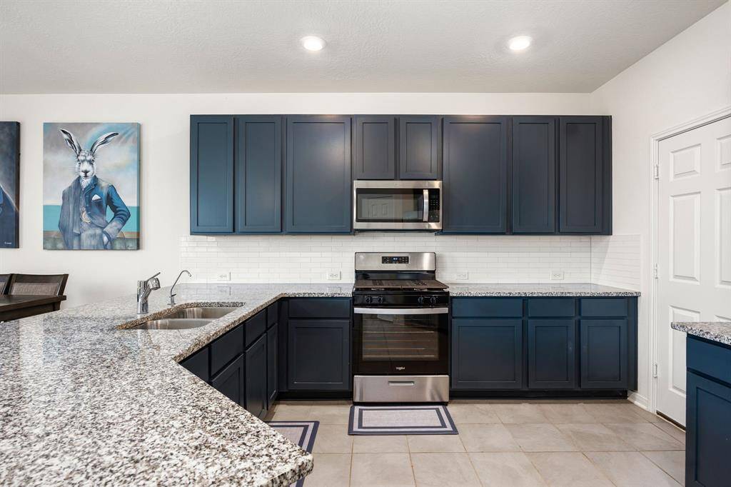 This kitchen is by far any chef’s dream! This spacious kitchen features large windows, dark cabinets, granite countertops, SS appliances, modern tile backsplash, recessed lighting and space for breakfast bar and a walk-in pantry all overlooking your huge family room.