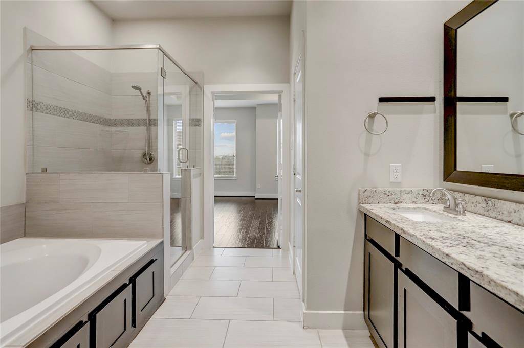 The Primary Bathroom features a double vanity, soaking tub, walk-in shower with bench, enclosed toilet room and access to the oversized walk-in closet.