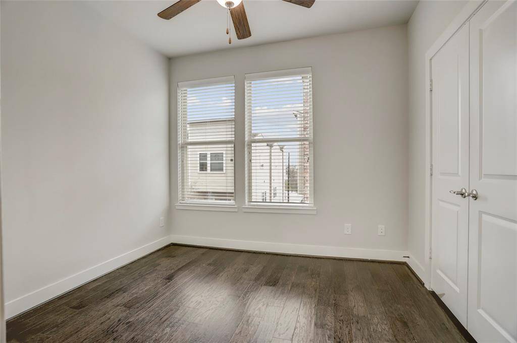 3rd Floor Secondary Bedroom with en-suite bathroom, a spacious closet & wood floors.
