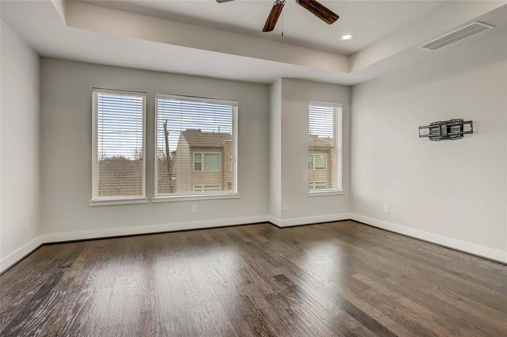 The Primary Bedroom is spacious enough for a sitting area, wood floors, raised ceiling detail, LED recessed lights and a wall of windows allowing for wonderful natural light.