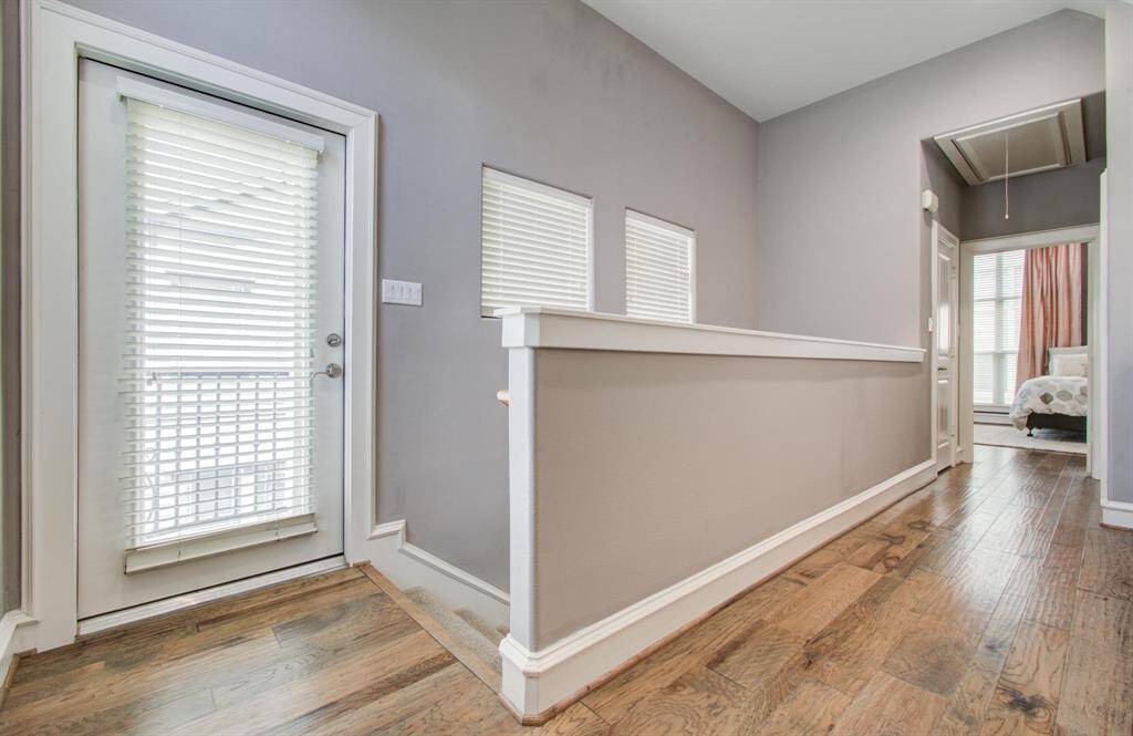 As we make our way to the third floor, you’ll find the primary suite level. Enjoy two access points to the balcony—one from the bedroom and one from the hallway. The laundry room is conveniently located just before you enter the spacious primary retreat.