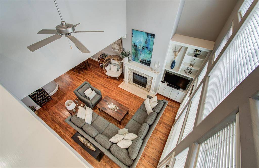 Just before entering the primary bedroom, take in the beautiful view overlooking the living area below. The open ceiling design highlights the incredible height and adds to the home’s bright, airy feel.