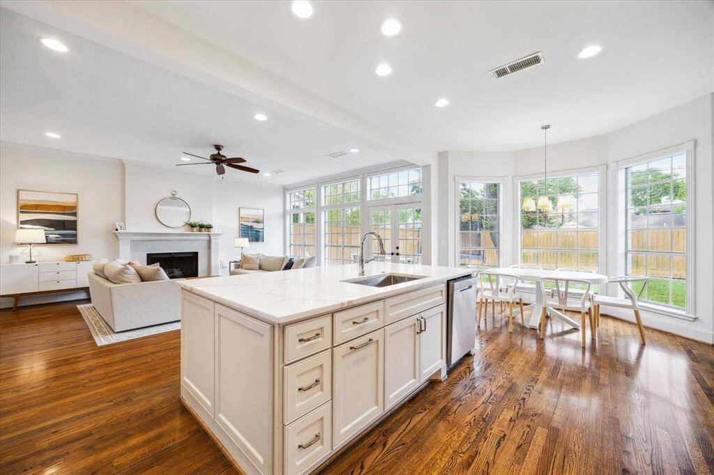 Looking back into the great room from the mudroom, the grandeur and spaciousness of the home are immediately evident. French doors, positioned opposite the island, open to a covered porch, extending the living space outdoors.