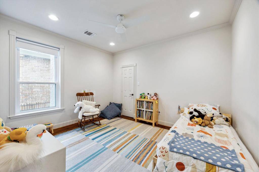 This secondary bedroom features an east-facing window and a spacious walk-in closet. To the left, you'll find the entrance to the Jack & Jill bathroom.