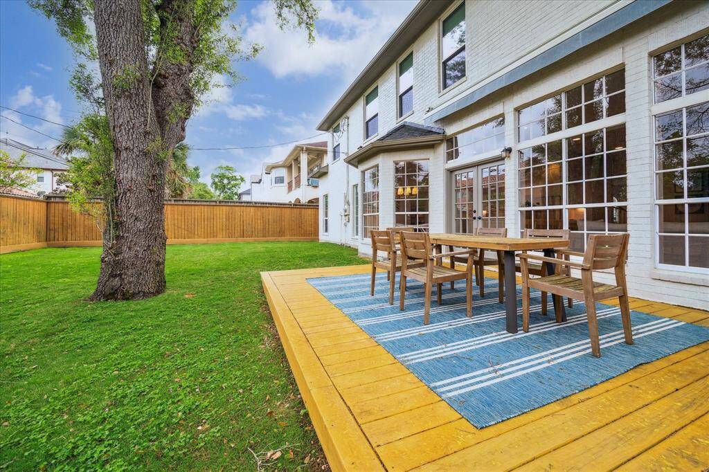 The spacious backyard has been beautifully updated with a wood patio deck, ideal for dining and entertaining outdoors.