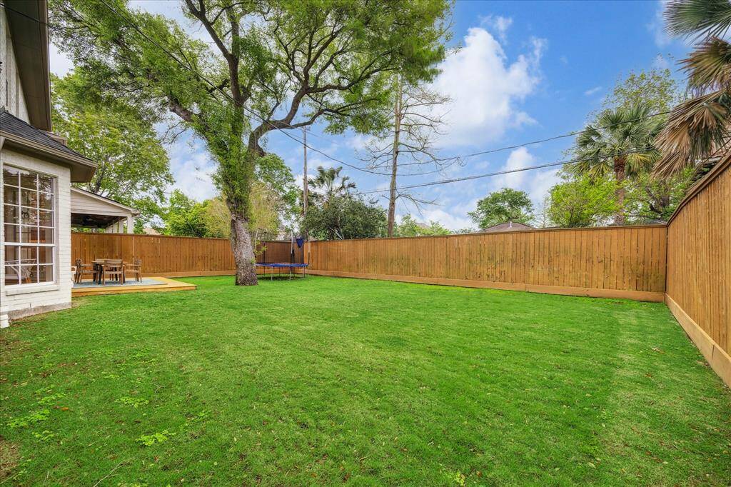 A different perspective of the stunning backyard highlights the recently replaced cedar fence, enhancing both privacy and the overall aesthetic of the space.