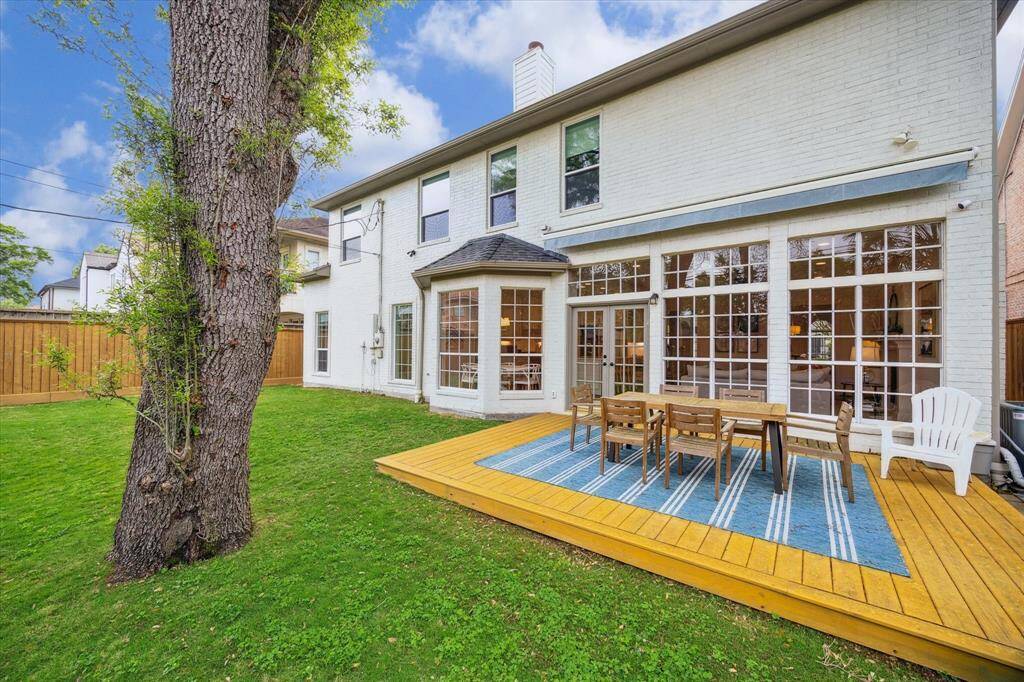 The wood patio, just off the living room, offers a seamless transition between indoor and outdoor living spaces.