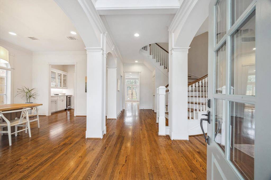 This breathtaking five-bedroom residence exemplifies exceptional craftsmanship and refined finishes, highlighted by intricate millwork and beautiful hardwood flooring throughout.