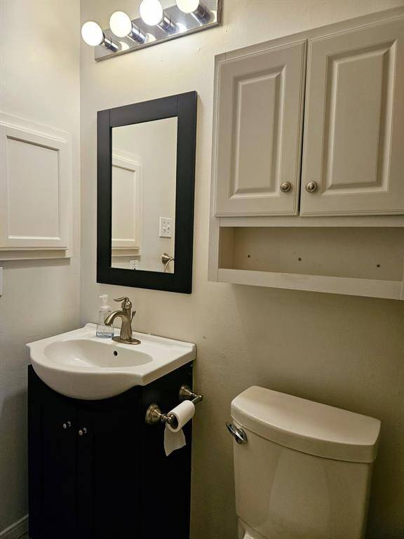 A streamlined yet functional space, this half bath is complete with all the essentials.