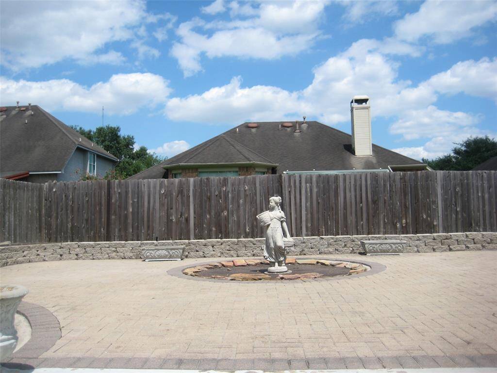 The patio is a lovely outdoor retreat with ample space for seating and decor. Charming ornamental touches make this an ideal spot for unwinding or entertaining under the open sky.