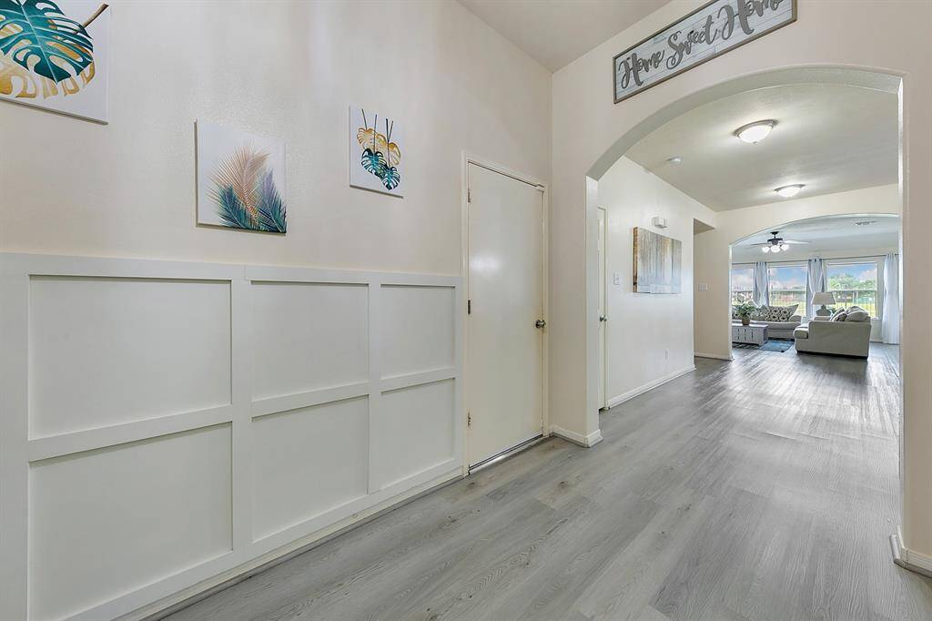 The coffered entry wall creates a striking first impression, with its elegant design and detailed craftsmanship. This architectural feature adds depth and sophistication, setting the tone for the rest of the home.