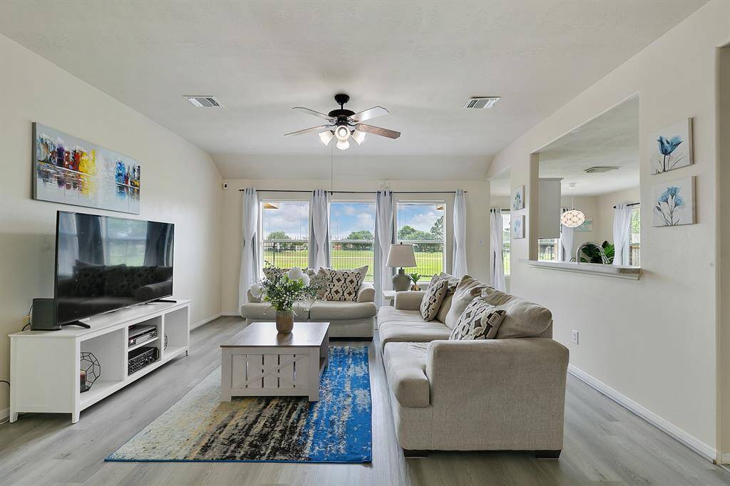 The family room boasts a stunning wall of windows that frame breathtaking views of the backyard and This serene setting provides the perfect backdrop for relaxation.