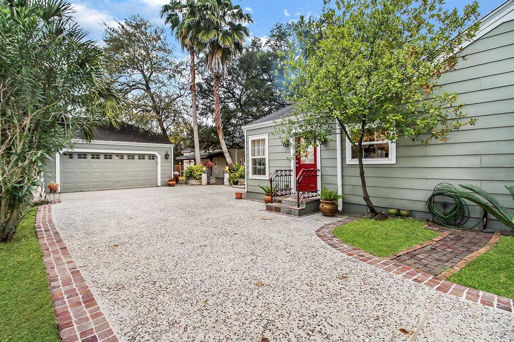 A second entry to the home leads to the kitchen/breakfast area. Note plenty of parking space and turnaround space between the main house and garage in this pea gravel driveway. Detached garage is large and can easily accommodate two SUVs