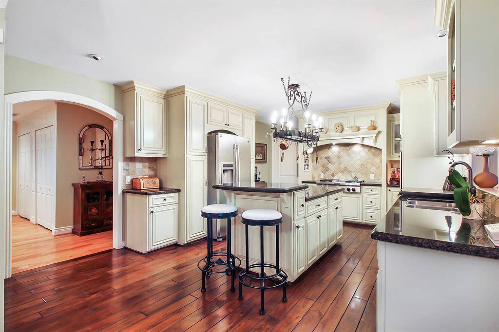 A quick last look of this very nice and functional kitchen. Notice arched doorways and very stylish custom built cooking area with travertine backsplash.