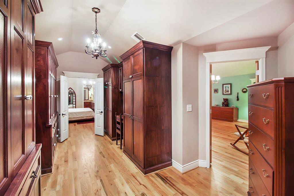 Large walk-in closet connects the bedroom/study (in the foreground) and the master bedroom (in the background).