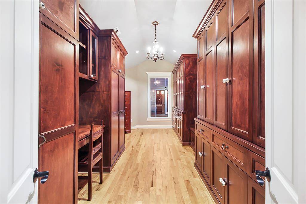 Custom built, floor to ceiling cabinets were a 2012 addition to the house. Notice chandelier – spotlights combo lighting and dressing vanity. Closet space can be easily divided for multiple people as needed.