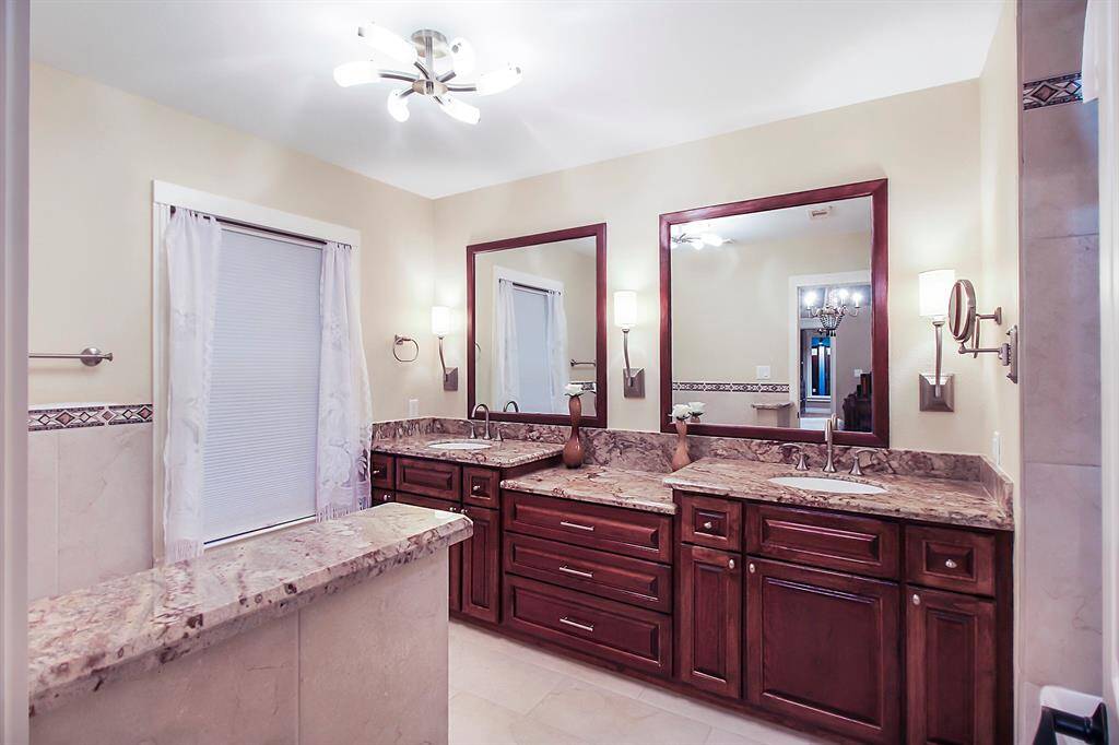 En suite bathroom serving the master bedroom has a well-planned out sink/cabinet arrangement, modern bathroom appliances, bidet besides the toilette, and a brushed nickel lighting package.