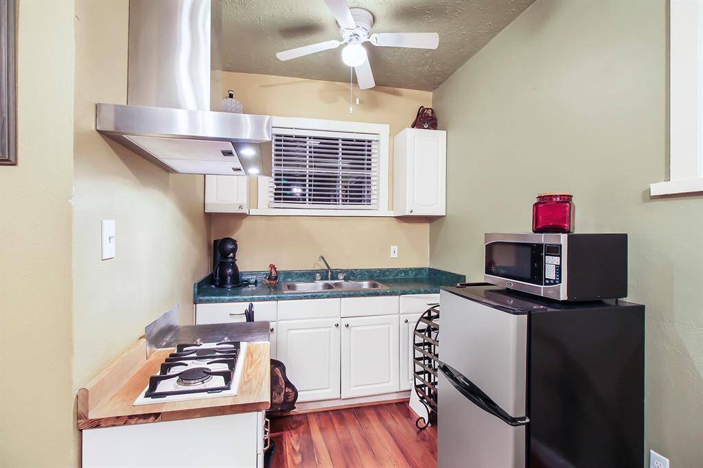 The kitchenette area was remodeled in 2012. That is when the new stainless steel range hood and new gas burners were installed. Just like in the main house, there is a window over the kitchen sink. It comes with a refrigerator and microwave oven.