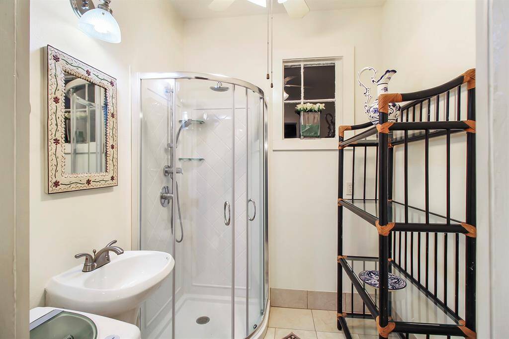 The guest house bathroom comes with a walk-in shower, toilette, and wash bin. Remodeling year is 2012 as well. There is also a functional small washing machine installed.