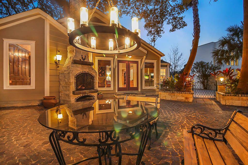 We revisit the center seating area of the back yard with this night picture. Observe complete outdoor lighting package, including an all-weather outdoor chandelier!