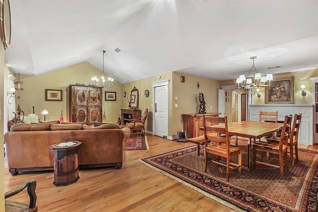 Good size family and dining room combo can easily accommodate large furniture pieces. A frame ceiling provides plenty of airspace in the living area. Notice tasteful chandeliers and natural color tones. Gas burning fireplace provided heat for the whole house during the recent winter storm!