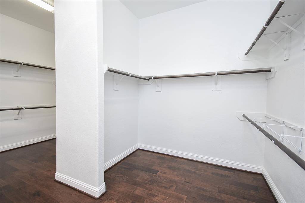 This spacious walk-in closet offers ample storage and organization with built-in shelving and double hanging rods—perfect for keeping everything neat, visible, and ready to go. Skylights were added to bring in beautiful natural light.