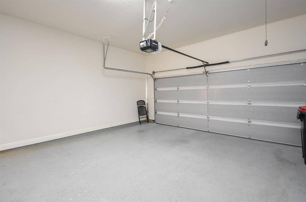 Garage equipped with a quiet, energy-saving DC opener featuring WiFi connectivity and battery backup, plus a new garage door opener (2022) and new spring (2023) for added peace of mind.