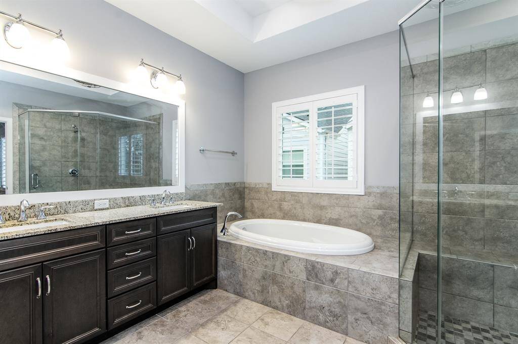 The primary bath features dual vanities, a soaking tub, and separate shower.