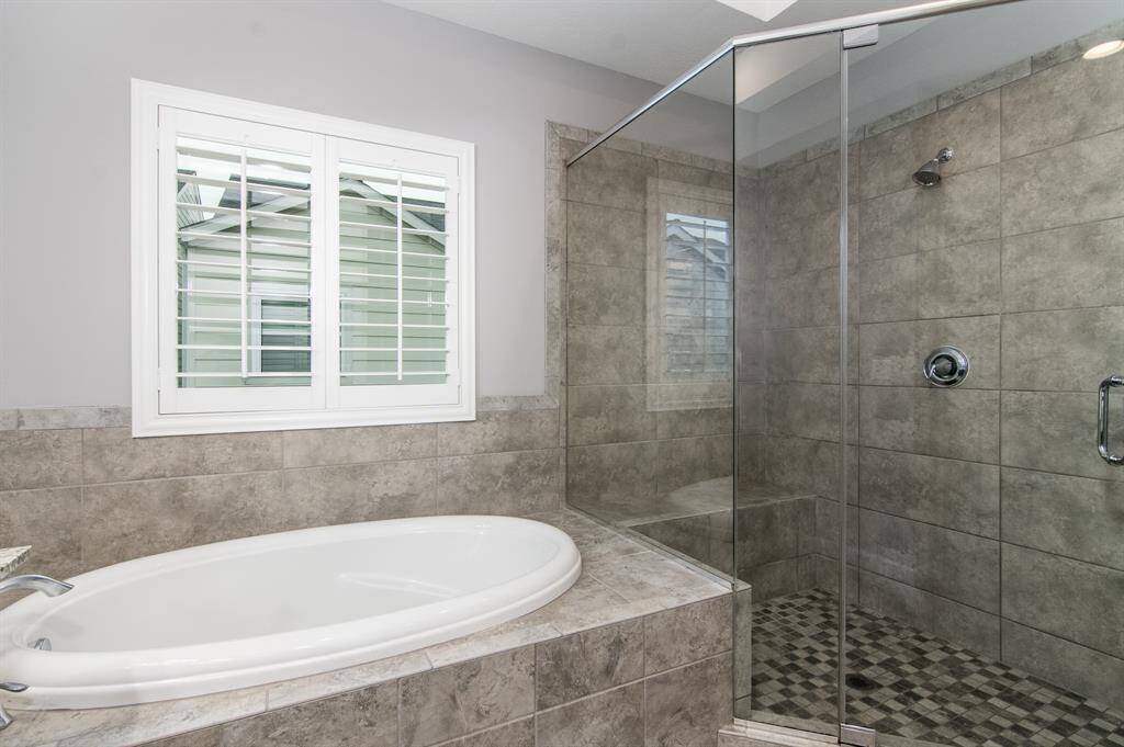 The large walk-in shower also has a bench.