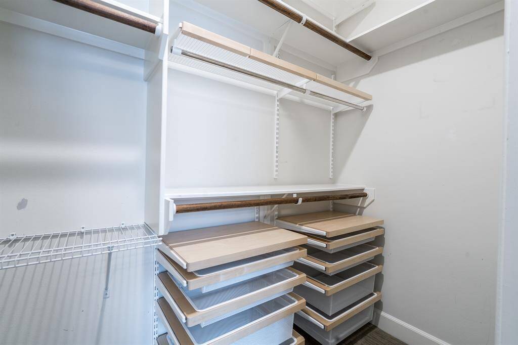 This secondary bedroom's closet features custom elfa storage to maximize storage.