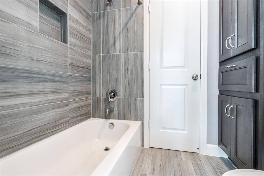 The shower/ tub combination is shared between the secondary bathrooms.