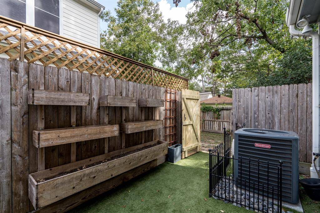 The backyard has custom built vertical flower beds.
