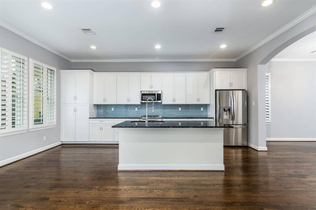 The large kitchen is equipped with modern finishes and a refrigerator!